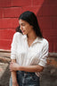 A young women in white shirt looking away